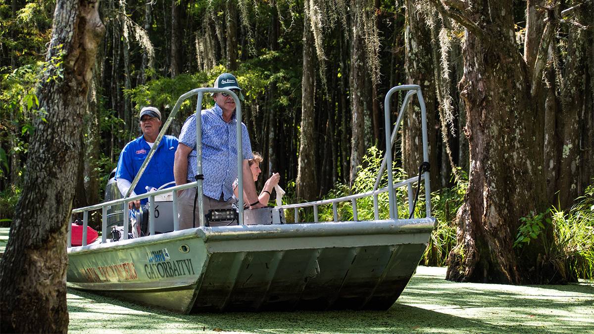 Family on airboat in the swamp lands in Louisiana